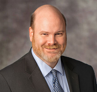 Bald man with beard and suit, Arnold Spencer, Esq., with 4.9-star reviews.