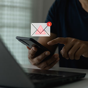 Hands on smartphone, email with warning. Dallas mail fraud attorneys.