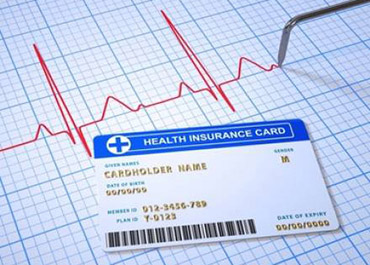 Health insurance card on EKG graph, symbolizing health, fraud, and legal implications.